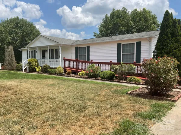a front view of a house with a yard and porch