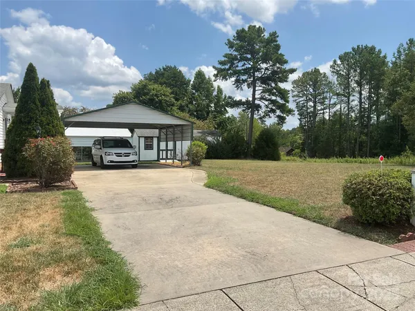 a view of house with yard and entertaining space