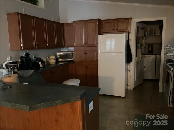 a kitchen with a sink a stove and a refrigerator