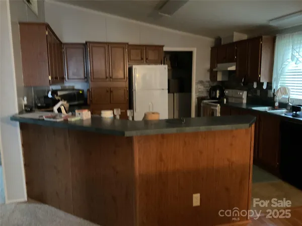 a view of kitchen with furniture and a window