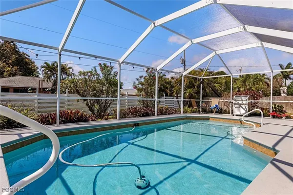 a view of a backyard with table and chairs under an umbrella