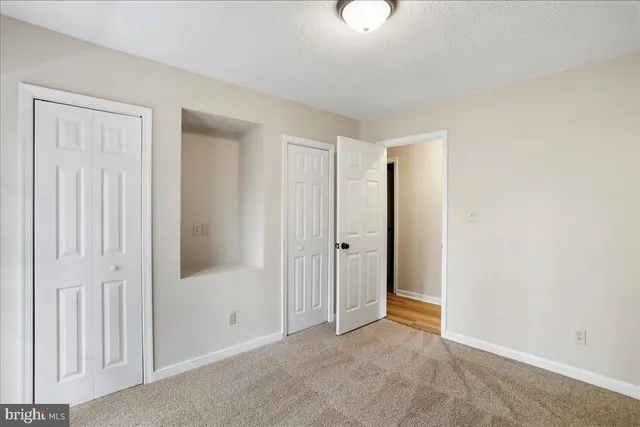an empty room with closet area