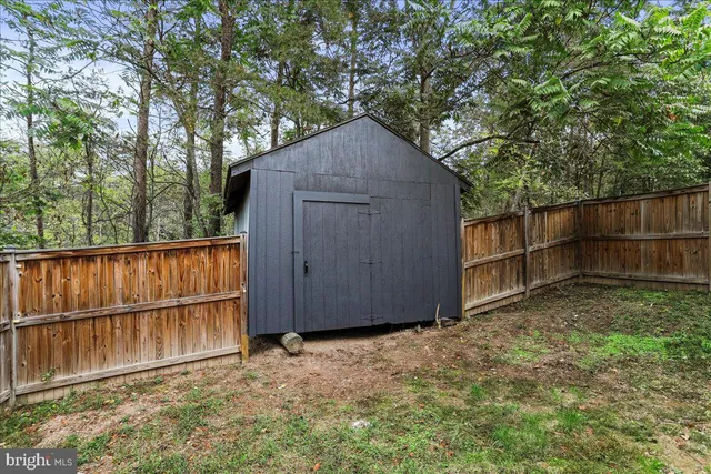 a backyard of a house with wooden fence