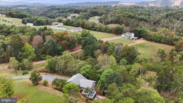 an aerial view of a house with yard