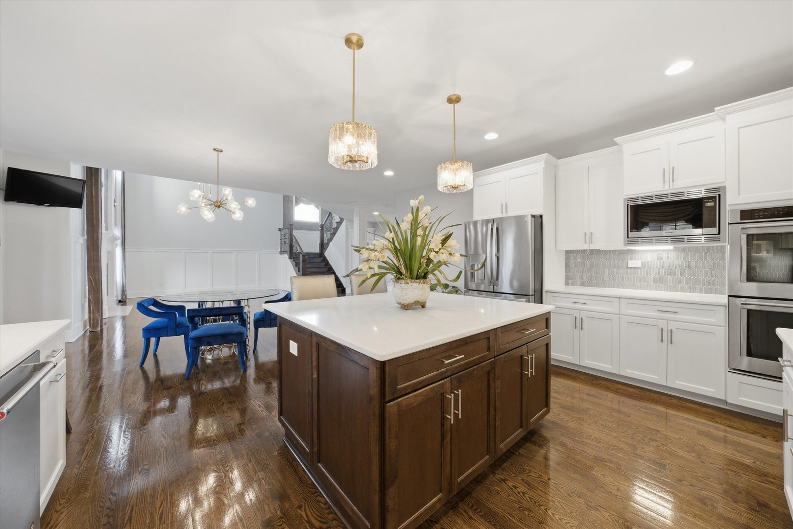 8613 High Stone Way Frankfort, IL 60423 - Photo 16 of 57 a kitchen with a stove a refrigerator a sink dishwasher with a dining table and chairs with wooden floor