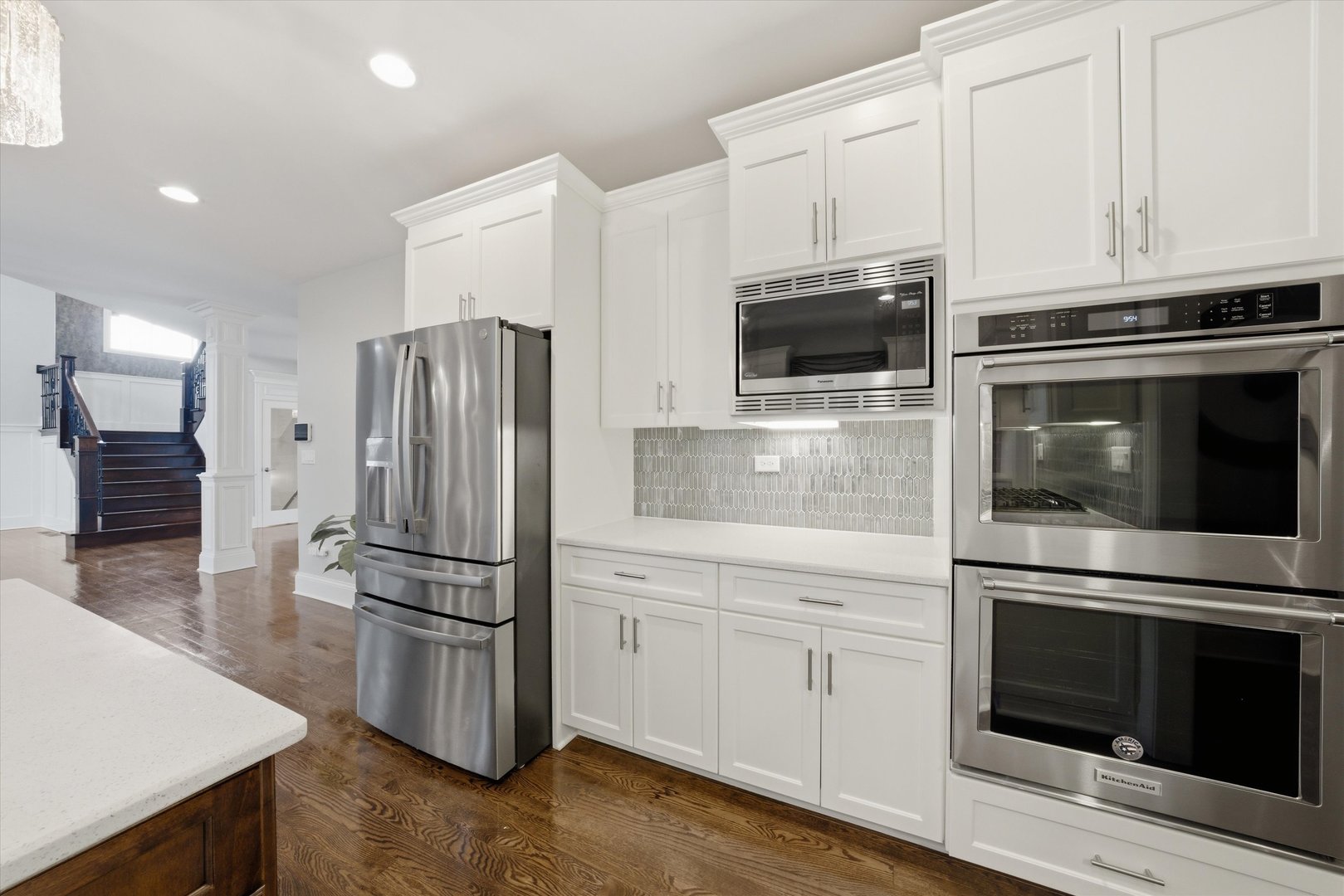 8613 High Stone Way Frankfort, IL 60423 - Photo 18 of 57 a kitchen with granite countertop white cabinets and stainless steel appliances