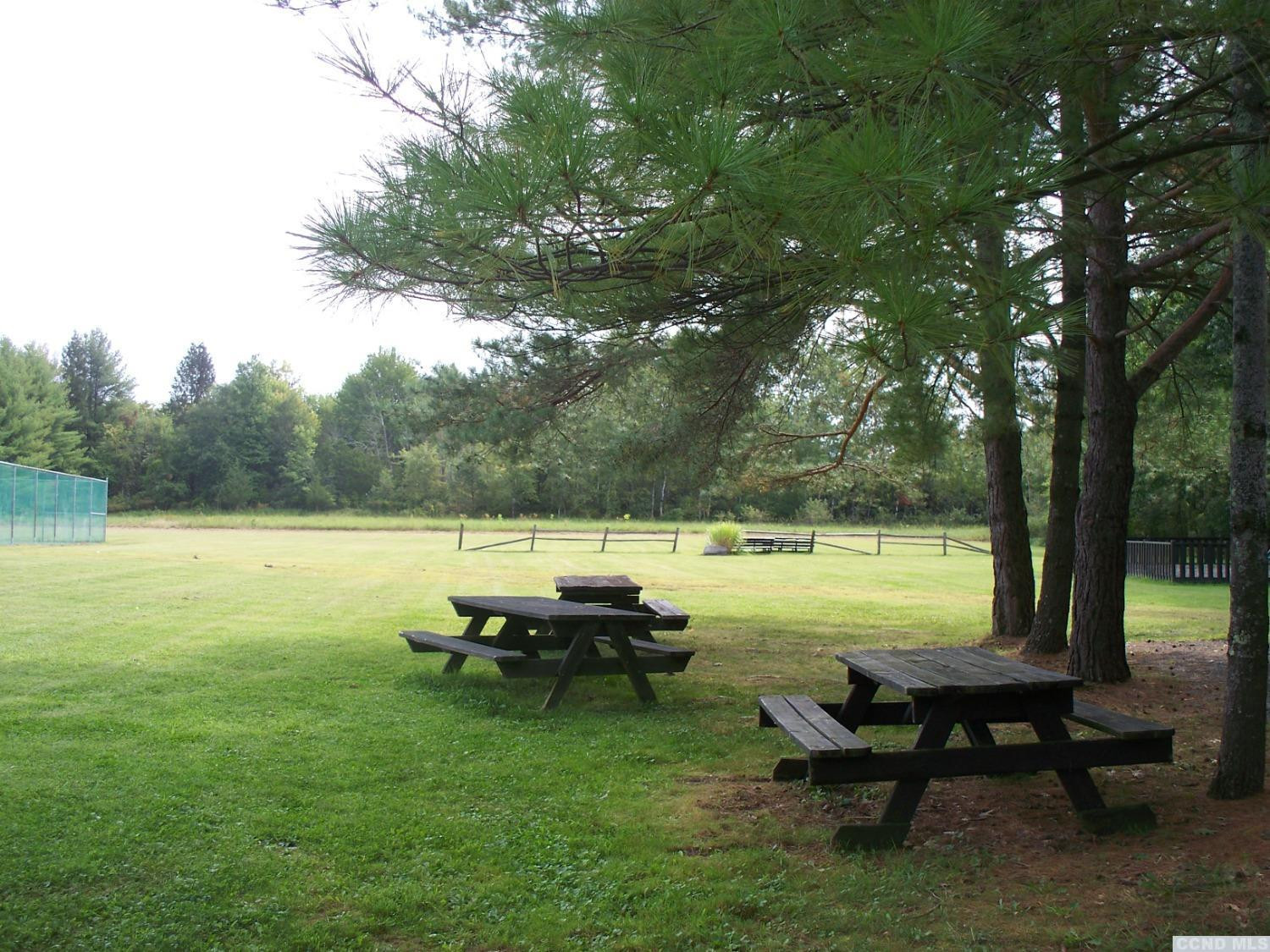 3125 Sleepy Hollow Road Athens, NY 12015 - Photo 10 of 14 a view of a lake with table and chairs under an umbrella