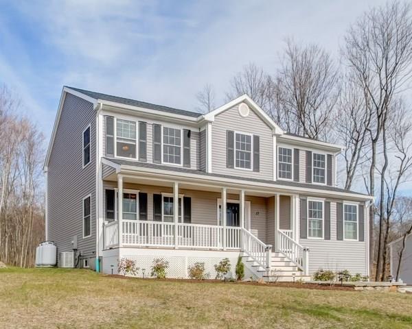 a front view of a house with a yard covered with snow in front of house