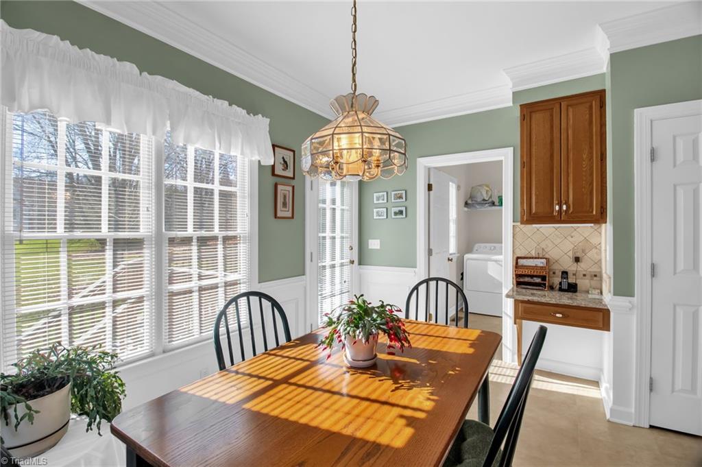 8115 Glengarriff Road Clemmons, NC 27012 - Photo 17 of 47 Breakfast space with windows overlooking backyard - laundry room adjoins space and desk area