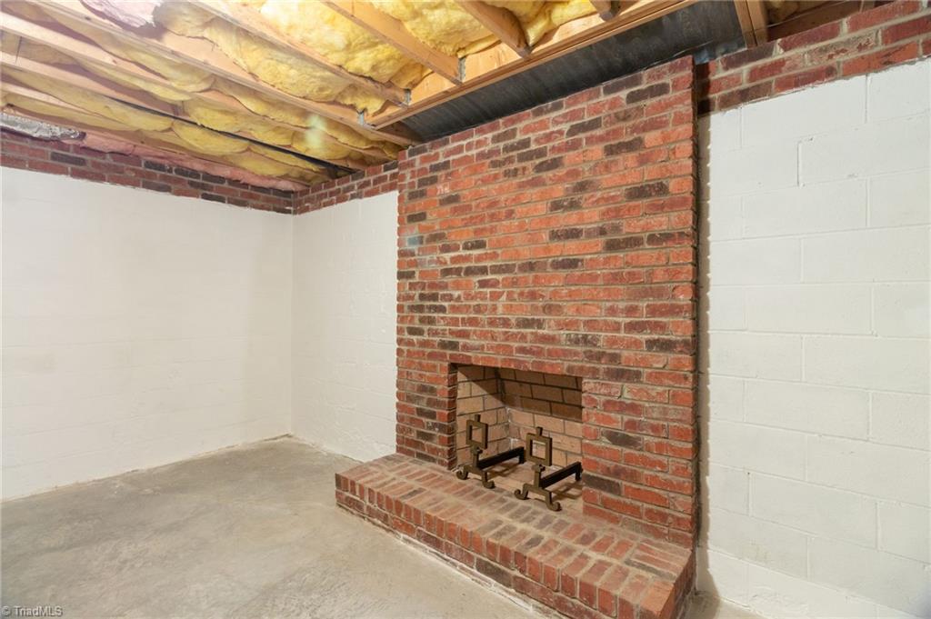 8115 Glengarriff Road Clemmons, NC 27012 - Photo 37 of 47 Brick fireplace in basement space