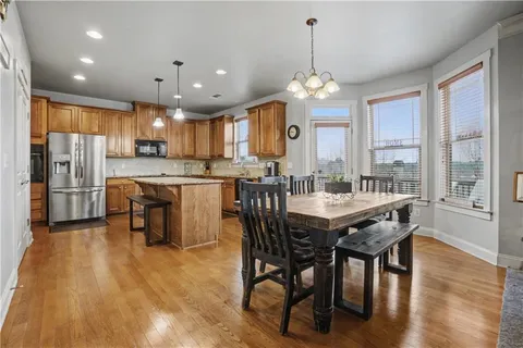 a living room with furniture kitchen view and a chandelier