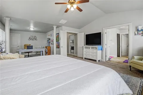 a bedroom with a bed and a flat screen tv