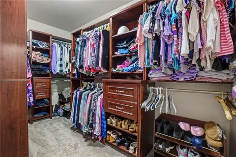 a bedroom with a bed and a chair