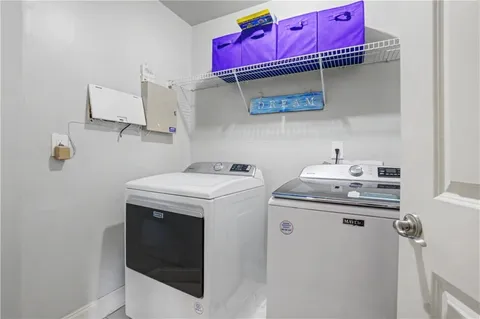 a view of a livingroom with furniture and staircase