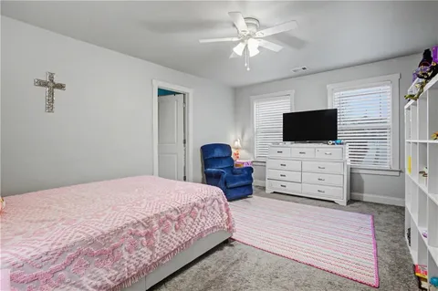 a living room with furniture and floor to ceiling window