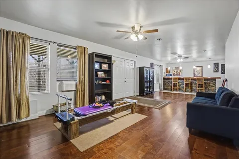 a view of a kitchen with furniture and wooden floor