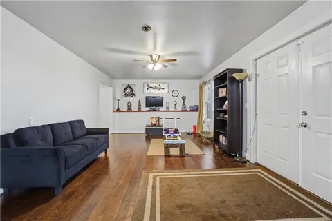 an empty room with a ceiling fan and window
