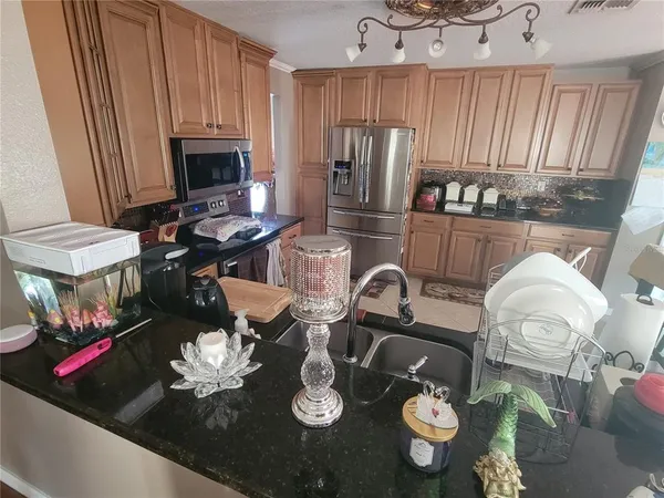 a kitchen with a sink appliances and cabinets