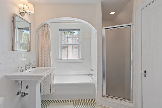 a bathroom with a sink a mirror and a bathtub