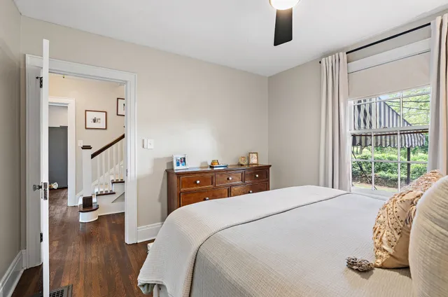 a bedroom with a bed and a large window