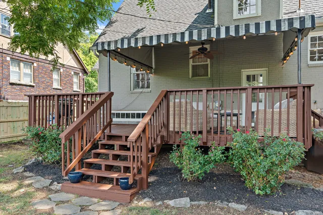 a front view of a house with a yard and potted plants