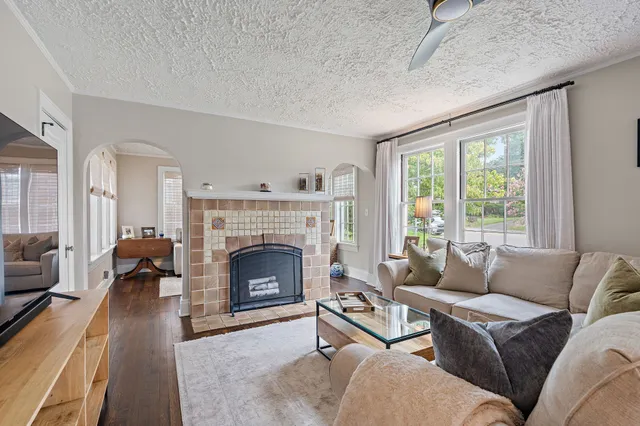 a living room with furniture and a fireplace