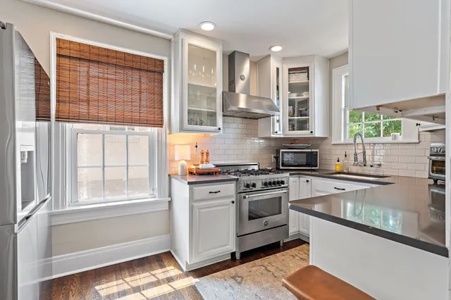 a kitchen with stainless steel appliances granite countertop a stove and a sink