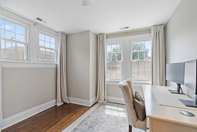 a view of a workspace with furniture and a window
