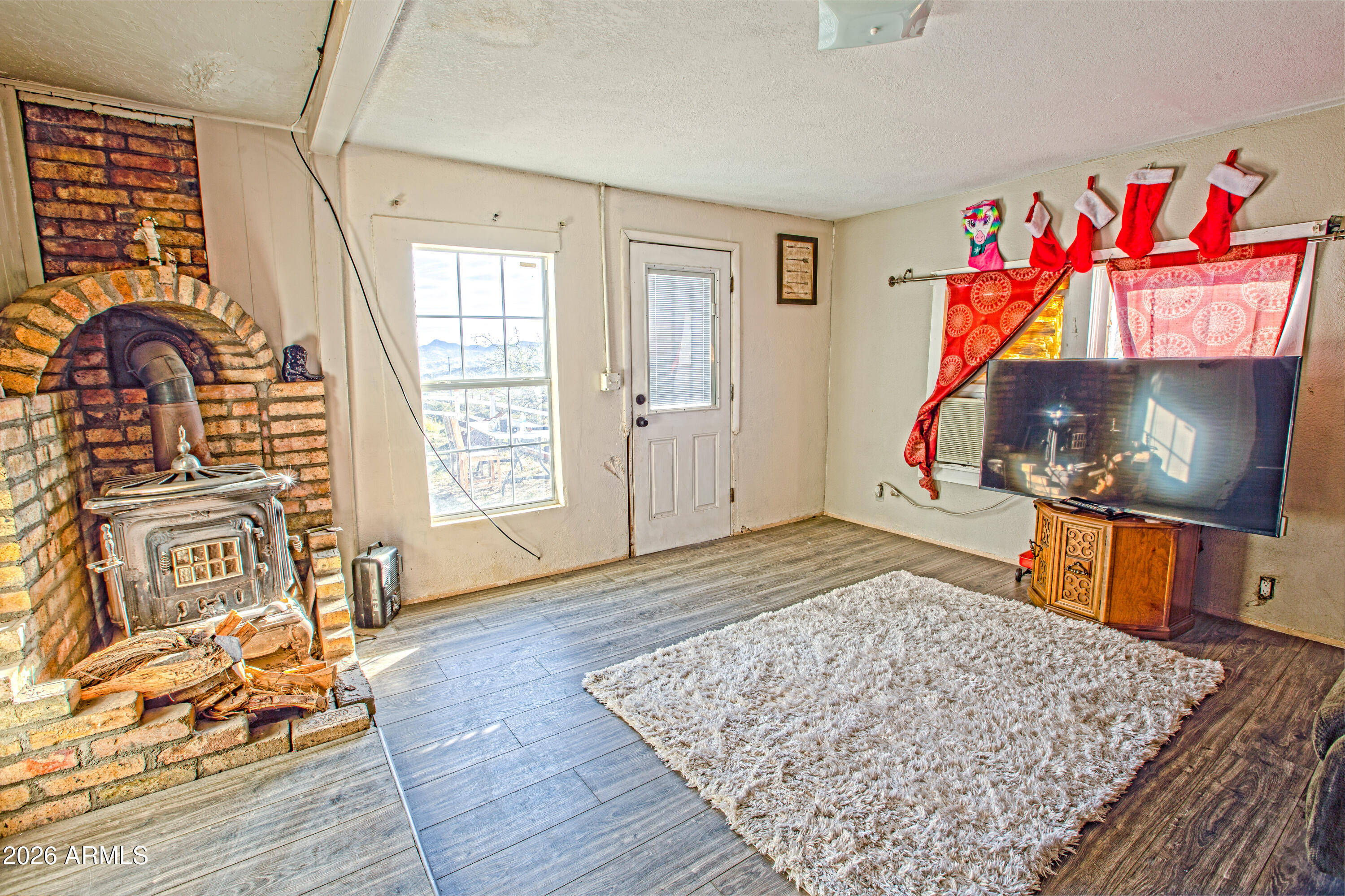 512 West Pinto Street Miami, AZ 85539 - Photo 15 of 27 a room with wooden floor pool table and windows