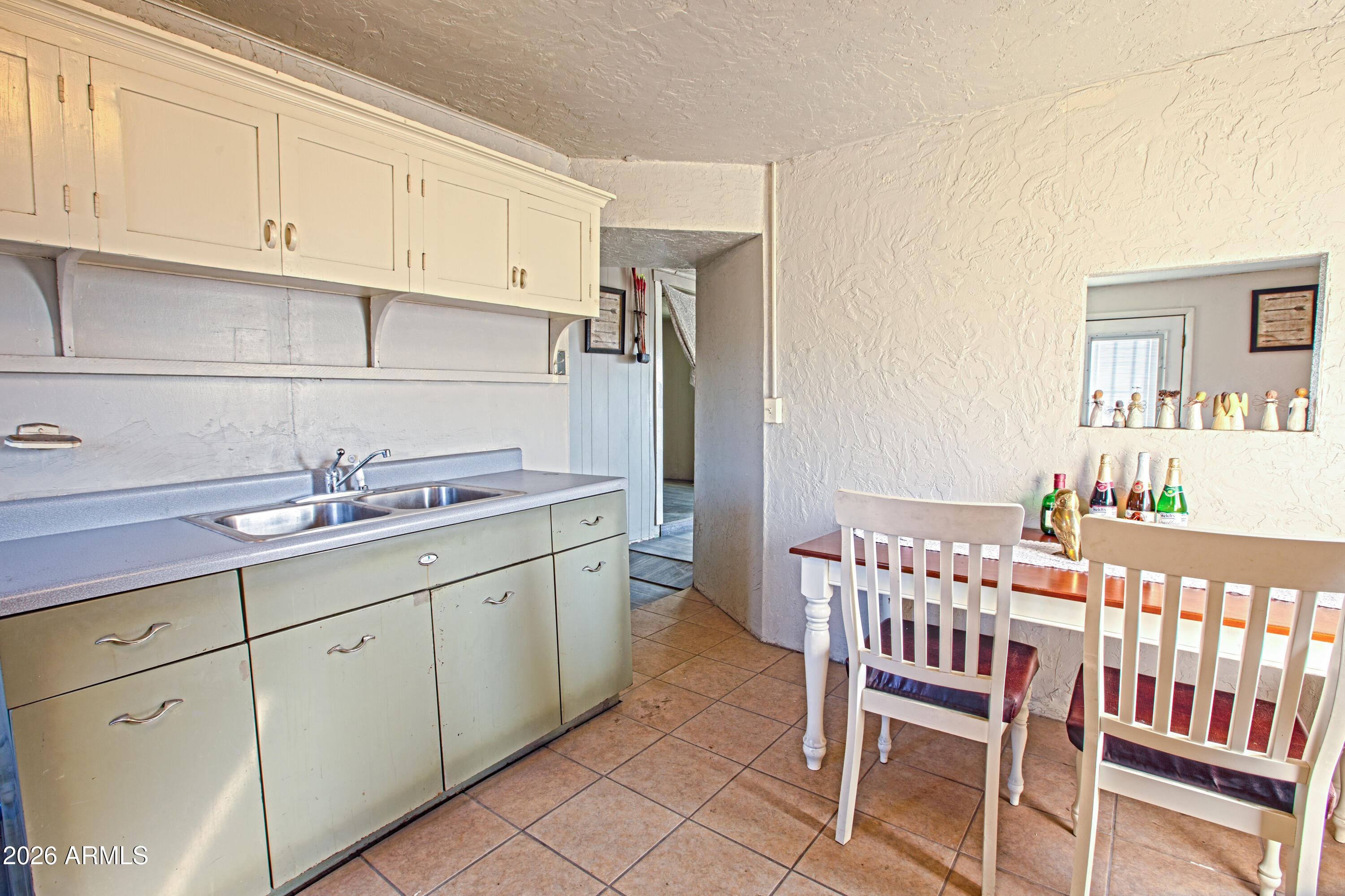 512 West Pinto Street Miami, AZ 85539 - Photo 22 of 27 a kitchen with a sink and cabinets