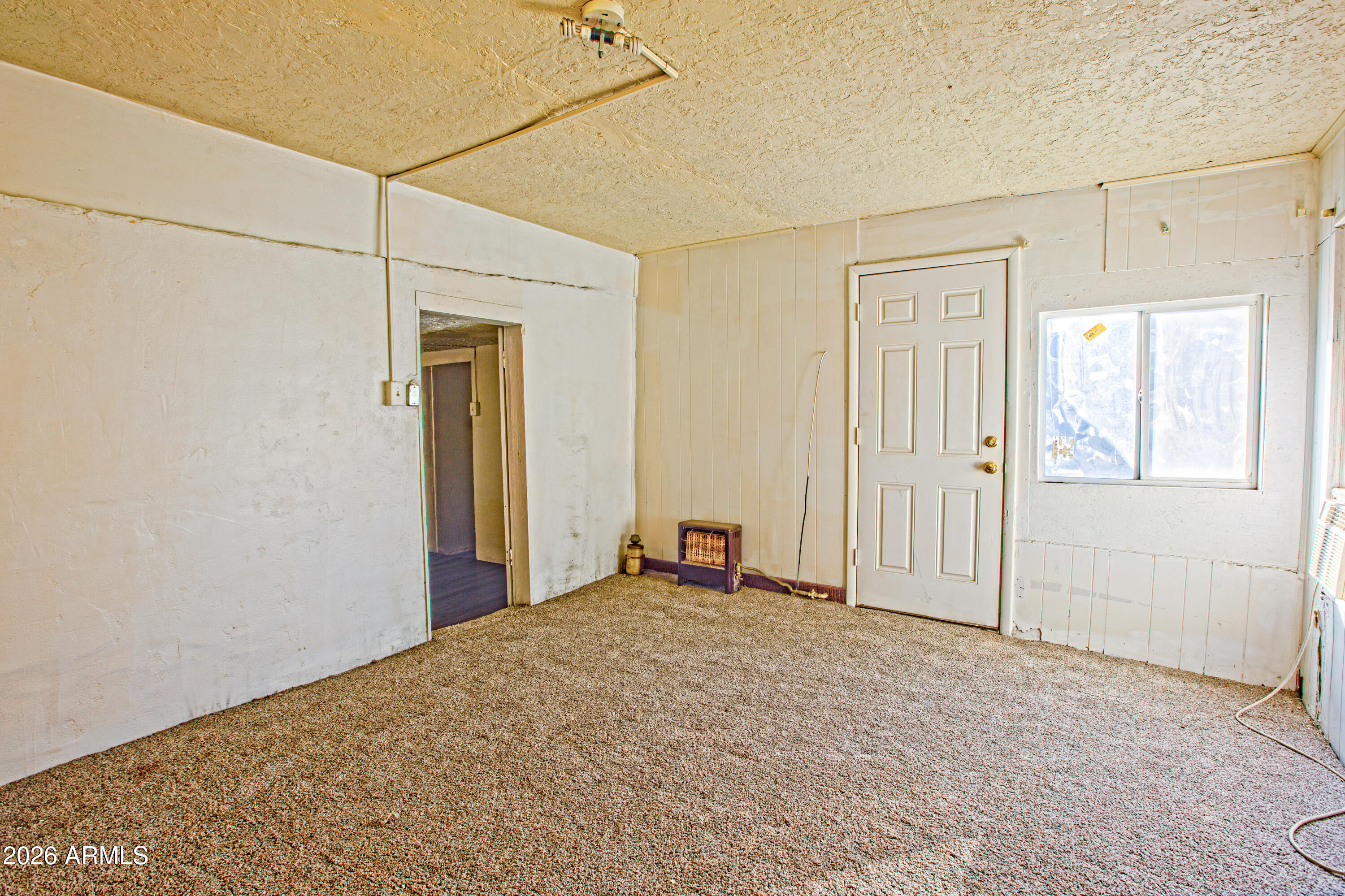 512 West Pinto Street Miami, AZ 85539 - Photo 25 of 27 a view of a livingroom with wooden floor and a window