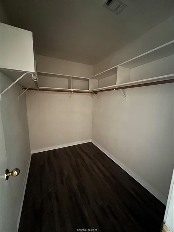 4611 Brompton Lane Bryan, TX 77802 - Photo 11 of 18 Walk in closet with dark wood-style floors