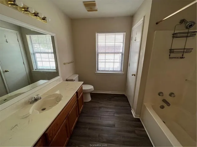 a view of a room with wooden floor