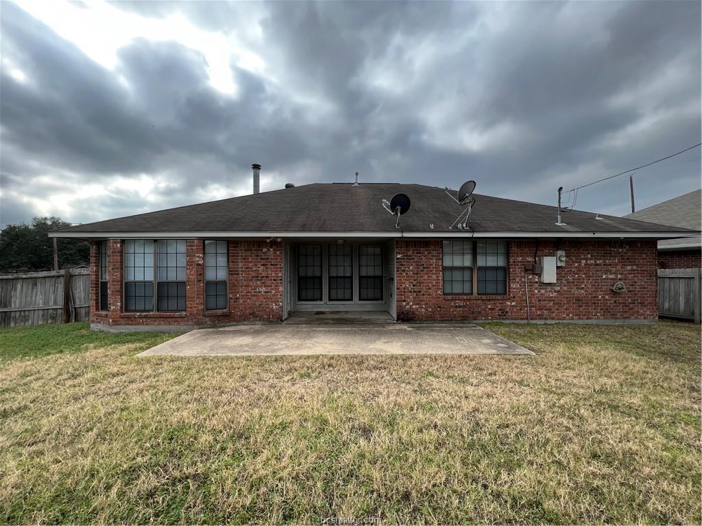 4611 Brompton Lane Bryan, TX 77802 - Photo 16 of 18 Back of property featuring a patio, brick siding, and roof with shingles
