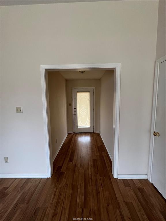 4611 Brompton Lane Bryan, TX 77802 - Photo 2 of 18 Hall with dark wood-style flooring and baseboards