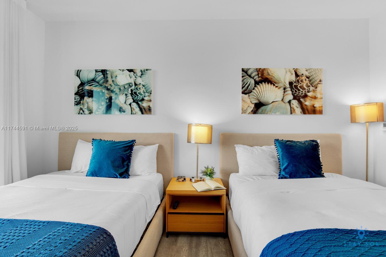 2602 East Hallandale Beach Boulevard, Unit R803 Hallandale Beach, FL 33009 - Photo 14 of 17 a bedroom with a bed and painting on the wall