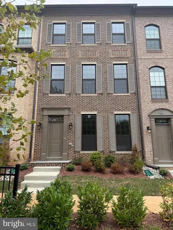 front view of a brick house with a yard
