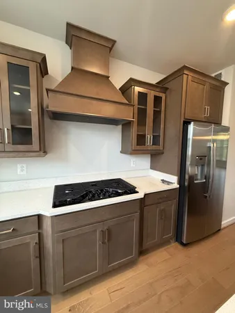 a kitchen with stainless steel appliances granite countertop a stove and a refrigerator