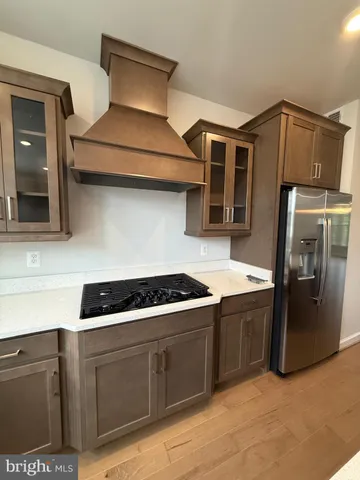 a kitchen with stainless steel appliances granite countertop a stove and a refrigerator
