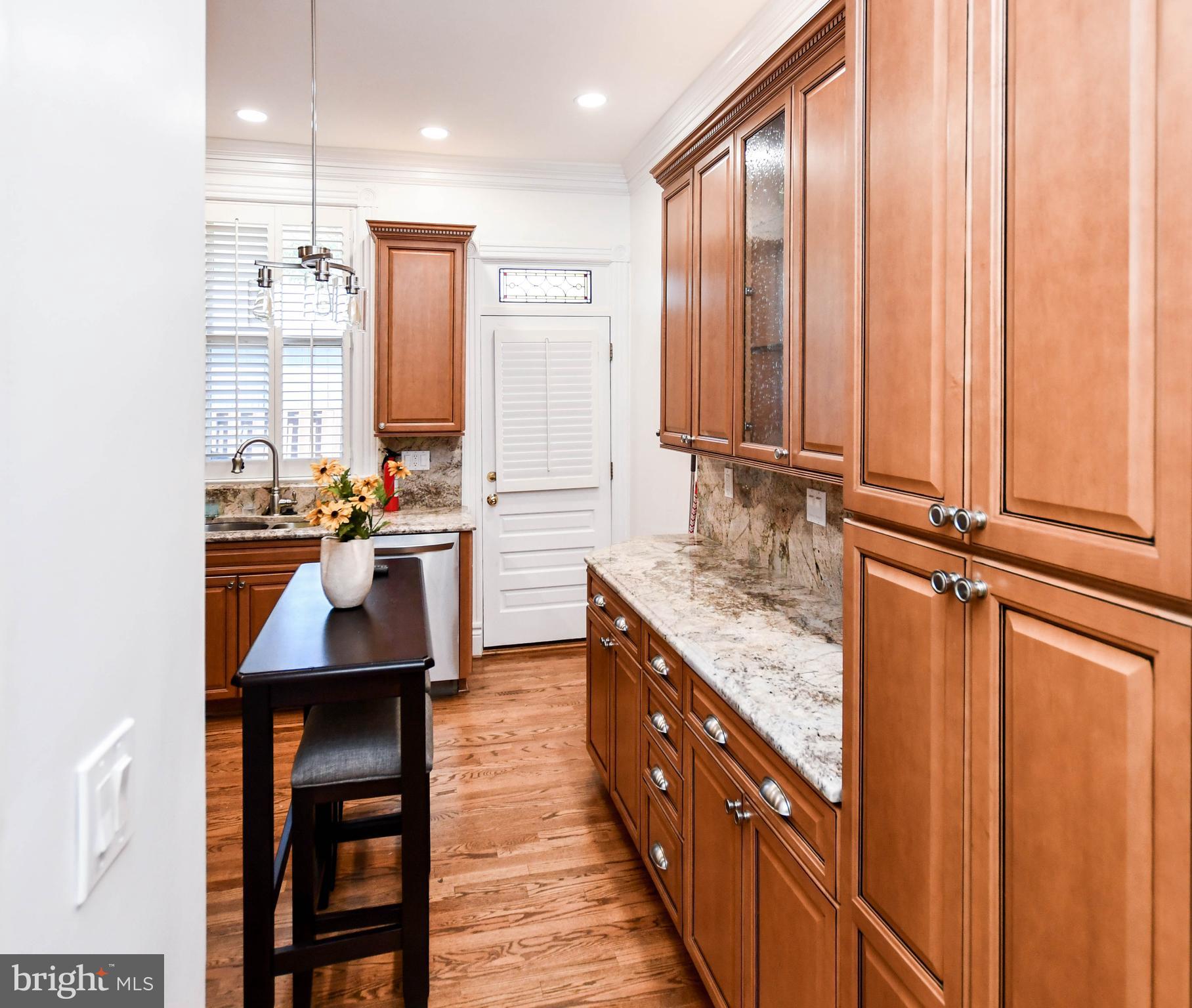 34 R Street Northeast Washington, DC 20002 - Photo 20 of 74 a kitchen with stainless steel appliances granite countertop wooden cabinets a sink and a stove