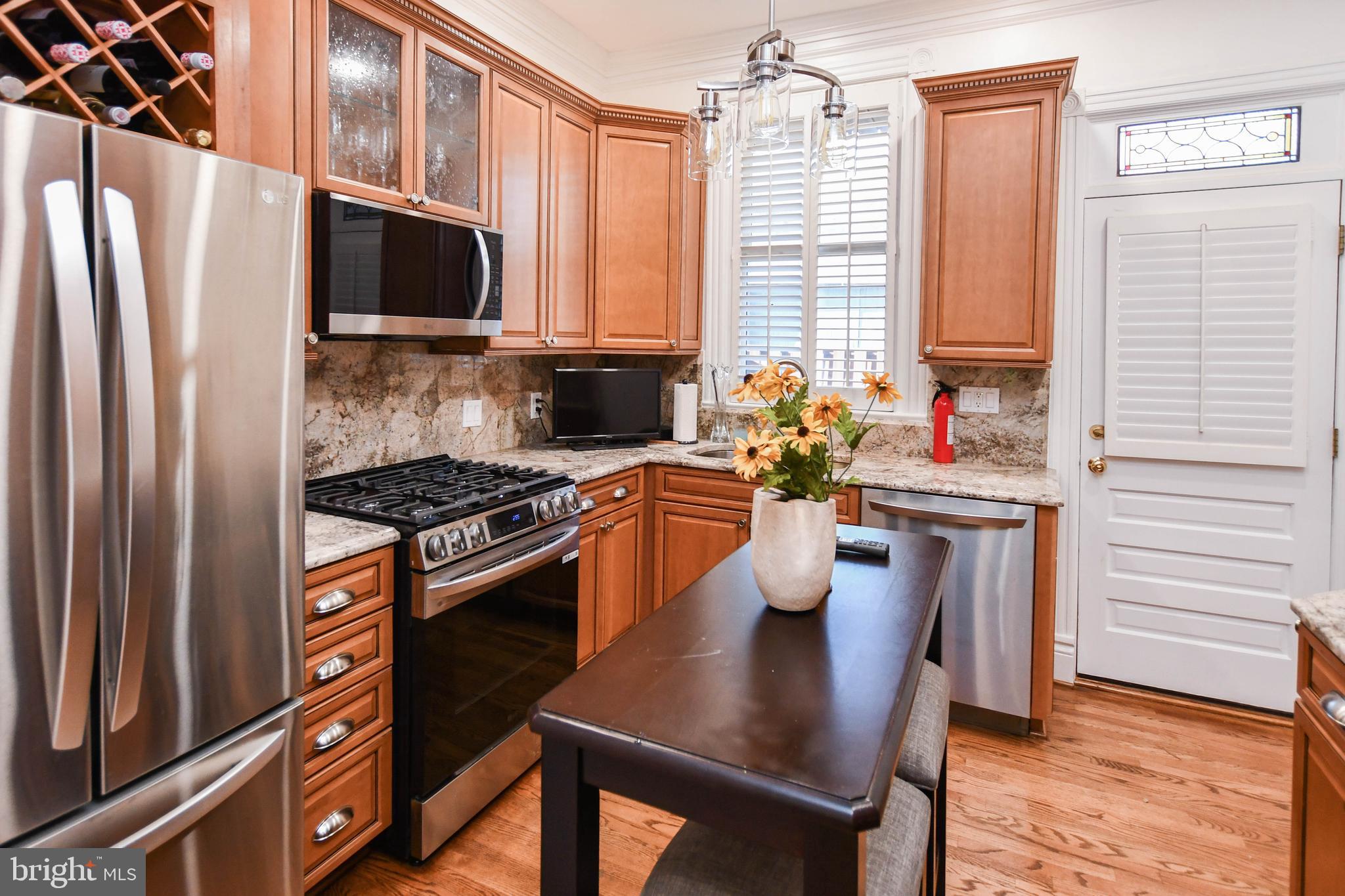 34 R Street Northeast Washington, DC 20002 - Photo 22 of 74 a kitchen with a refrigerator a stove a sink dishwasher and wooden cabinets