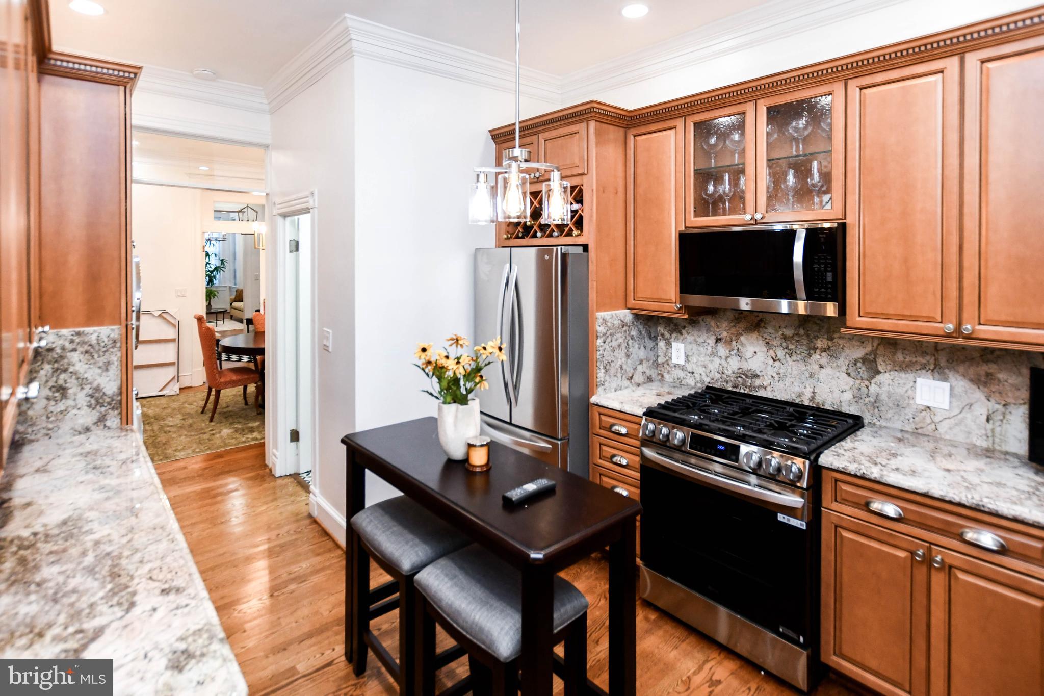34 R Street Northeast Washington, DC 20002 - Photo 23 of 74 a kitchen with stainless steel appliances granite countertop a stove refrigerator and microwave
