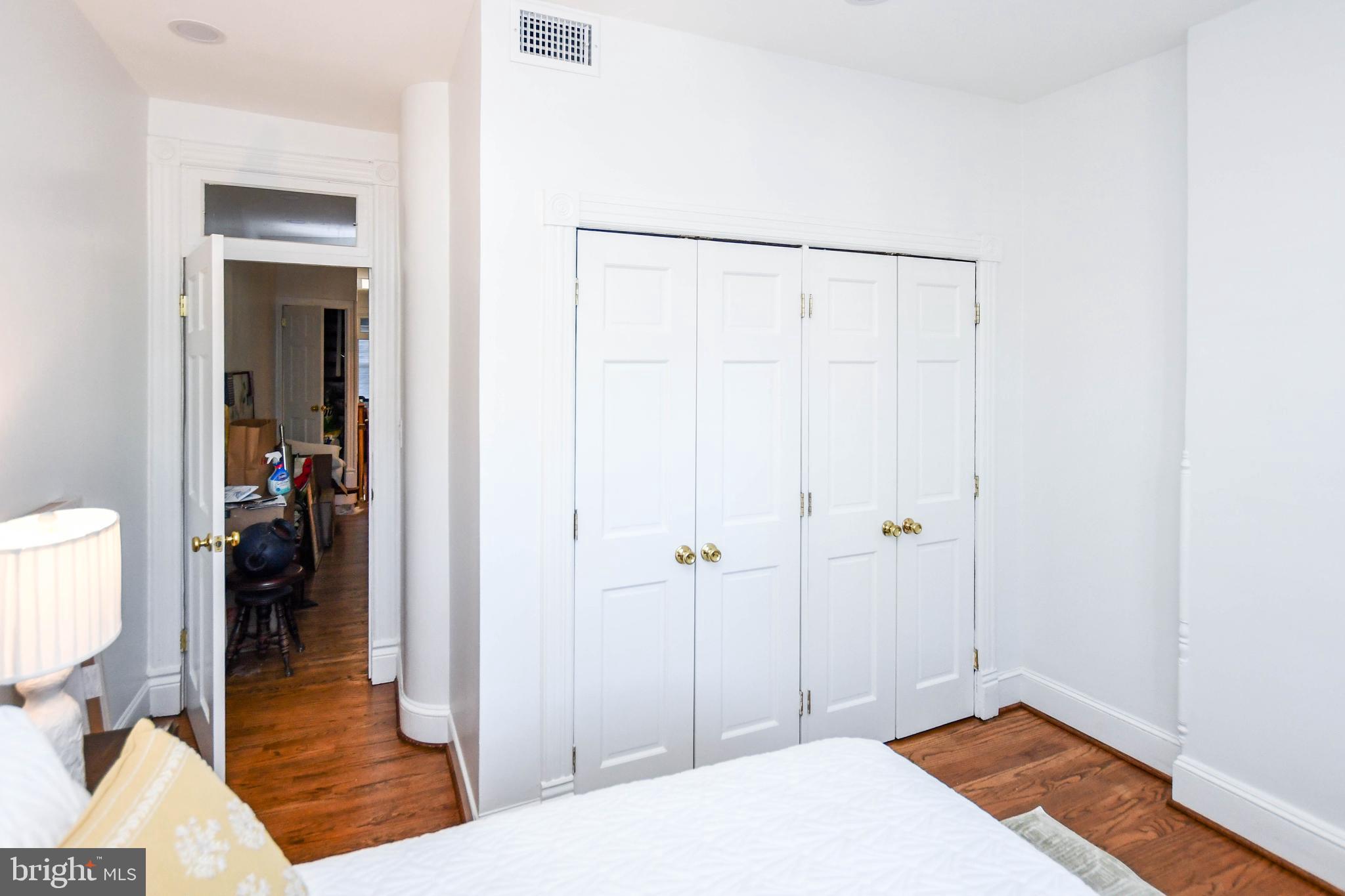 34 R Street Northeast Washington, DC 20002 - Photo 31 of 74 a bedroom with a bed and wooden floor