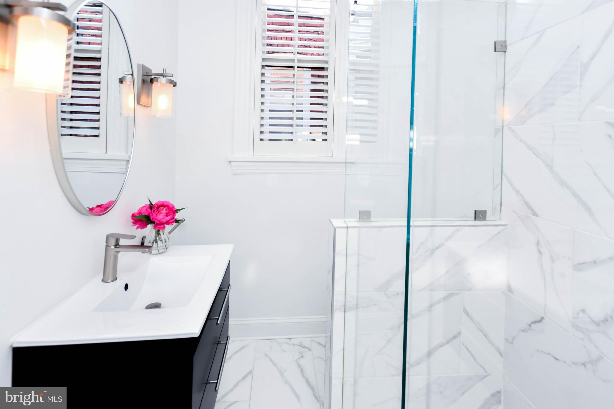 34 R Street Northeast Washington, DC 20002 - Photo 35 of 74 a bathroom with a bathtub sink and mirror