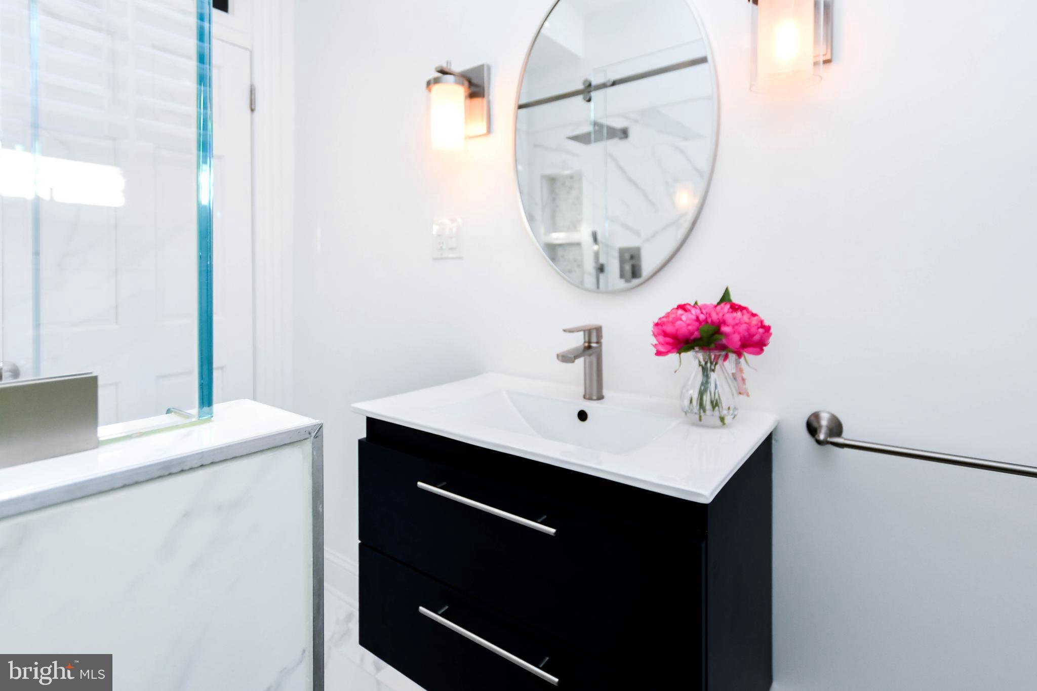 34 R Street Northeast Washington, DC 20002 - Photo 37 of 74 a bathroom with a sink vanity and a mirror