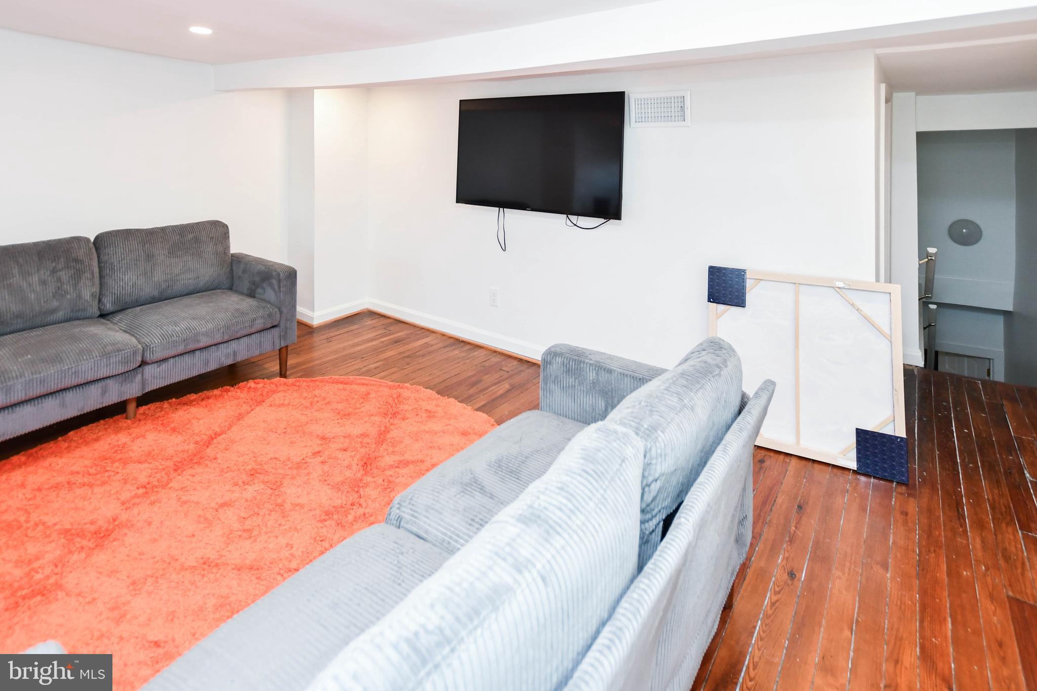 34 R Street Northeast Washington, DC 20002 - Photo 43 of 74 a living room with furniture and a flat screen tv