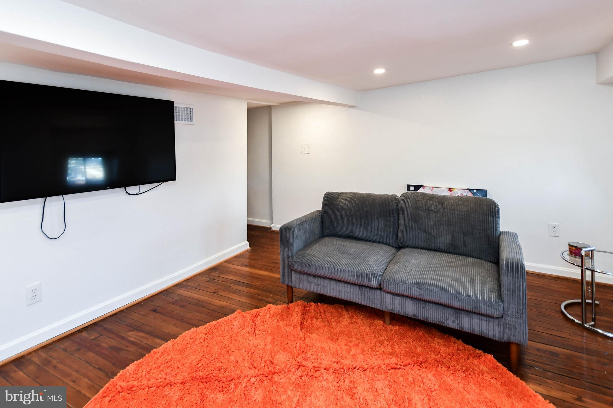 34 R Street Northeast Washington, DC 20002 - Photo 46 of 74 a living room with furniture and a flat screen tv
