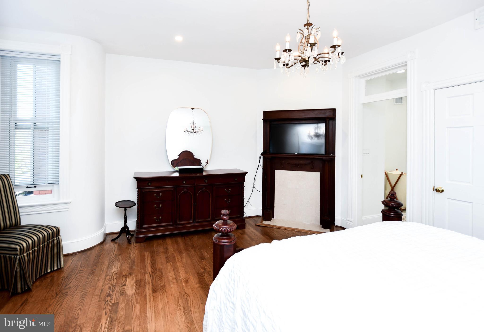 34 R Street Northeast Washington, DC 20002 - Photo 50 of 74 a bedroom with a bed and a chandelier