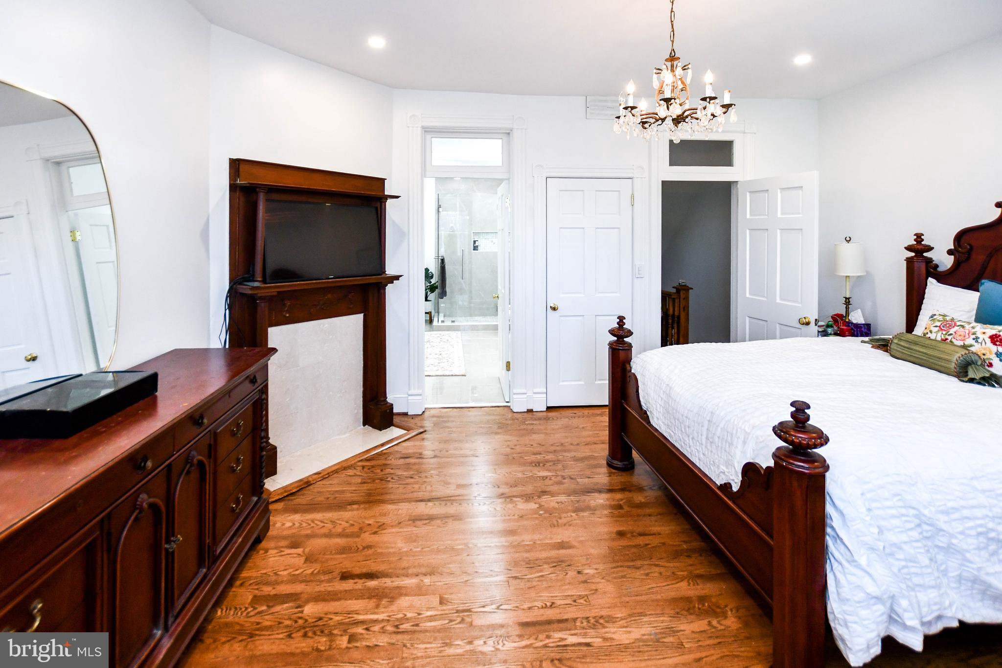 34 R Street Northeast Washington, DC 20002 - Photo 51 of 74 a spacious bedroom with a bed and a flat screen tv