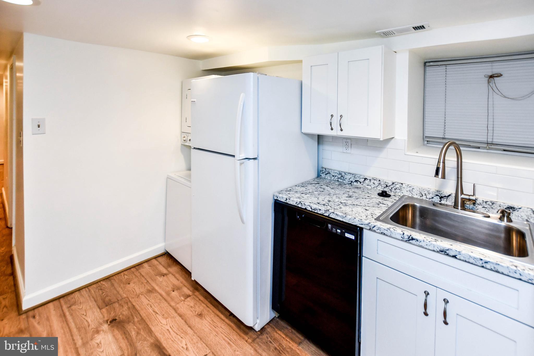 34 R Street Northeast Washington, DC 20002 - Photo 69 of 74 a kitchen with a sink and refrigerator